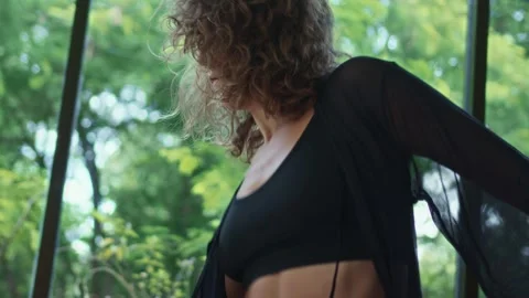Female dancer performs sensual sexy choreography in studio, tropical background Stock Footage 245373600