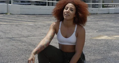 Female dancer posing on top of a parking garage Stock Footage 97037616