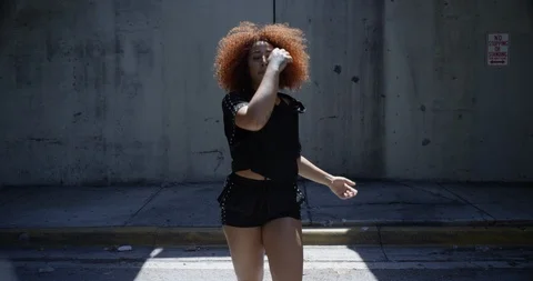 Female dancer posing under an overpass Stock Footage 97036360