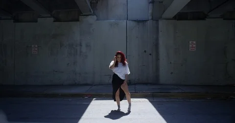 Female dancer posing under an overpass Stock Footage 97446436