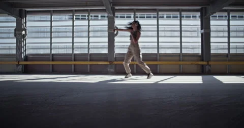 Female dancer walking backwards against window Stock Footage 213652989