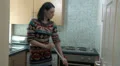 Female dancing while doing housework HD Footage