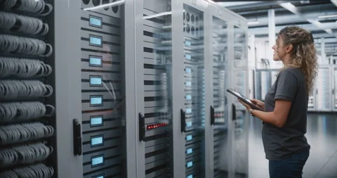 Female Data Center Engineer Inspecting Server Infrastructure with Tablet Stock Footage 344955627