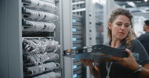 Female Data Center Engineer Replacing Network Switch in Server Rack Stock Footage 344966217