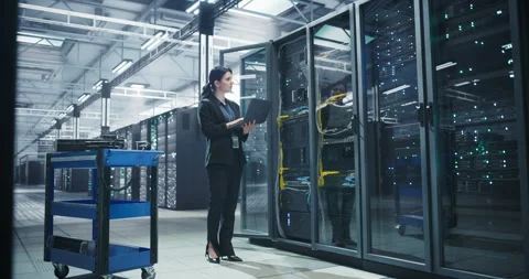 Female Data Center Specialist Using Laptop Computer Stock Footage 320865977