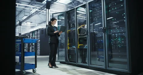 Female Data Center Specialist Using Laptop Computer Stock Footage 320865991