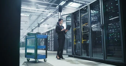Female Data Center Specialist Using Laptop Computer Stock Footage 320866002