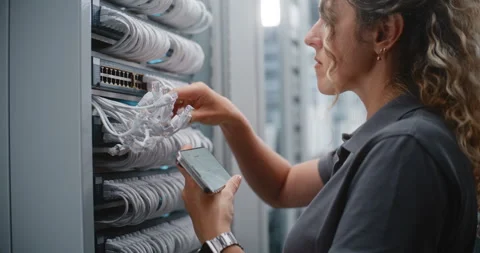 Female Data Center Specialist Verifying Rack Patching Against Digital Records Stock Footage 344973508