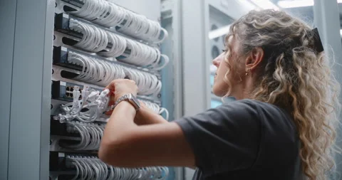 Female Data Center Technician Maintaining Patch Panel and Ethernet Connections Stock Footage 344953356