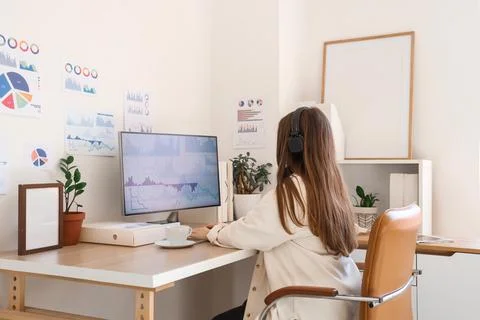 Female data scientist working with computer at desk in office, back view Stock Photos