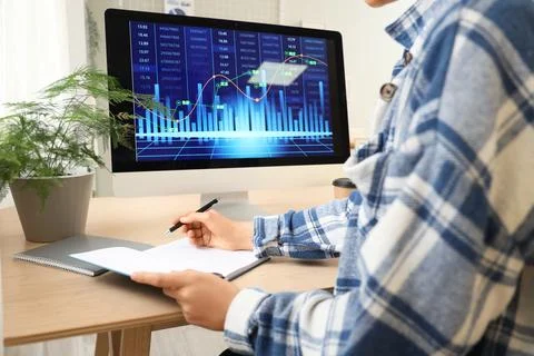 Female data scientist working with notebook at desk in office Foto stock