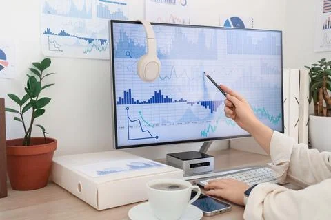 Female data scientist's hands working with computer at desk in office Foto stock