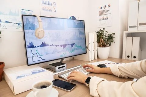 Female data scientist's hands working with computer at desk in office 写真素材