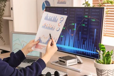 Female data scientist's hands working with diagrams at desk in office Stock Photos