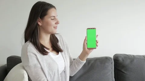 Female demonstrating android app. Green screen chroma key Video stock 91644706