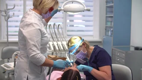 Female dentist at work with assistant Stock-Footage 159198751
