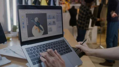 Female designer develops 3D design of clothes 库存照片