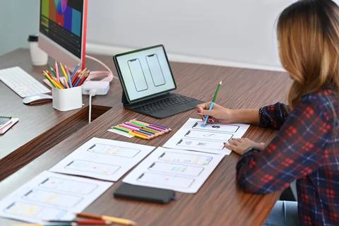 Female designer is drawing application template layout framework for mobile Stock Photos