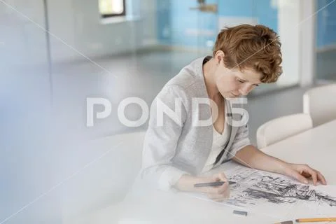 Female designer drawing sketch in office Stock Photos