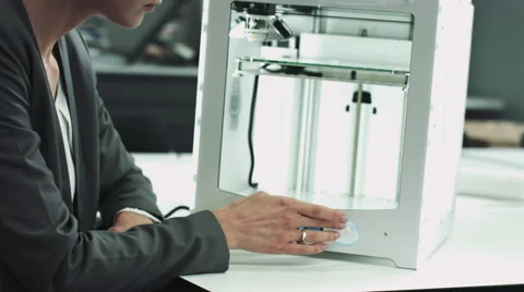 Female designer looking at 3D printed object in studio Stock Footage 55869731