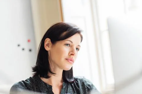 Female designer looking at computer in creative studio 스톡 사진