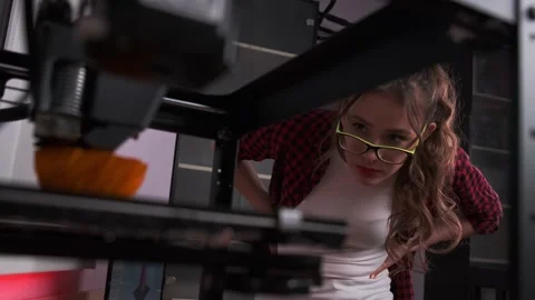 Female designer using a 3D printer. A student girl print prototype on 3D printer Stock Footage 153421239