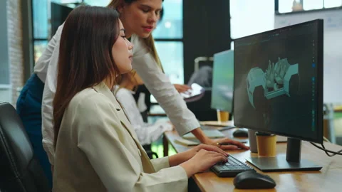 Female designer using computer to design ev car prototype at office. Stock Footage 234207478