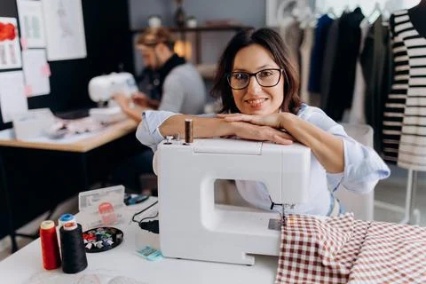 Female designer using sewing machine Stock Photos