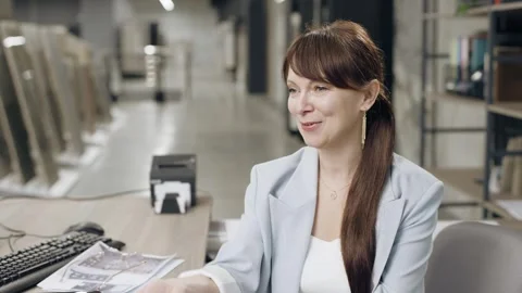 Female designer working and talking to client at desk in tile showroom Video stock 274393238