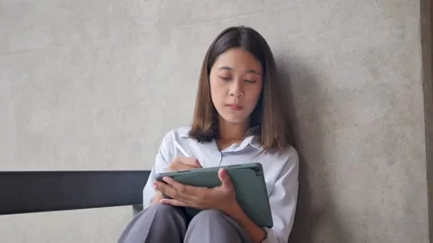 Female designer working on digital tablet download application. Stock Footage 201363156