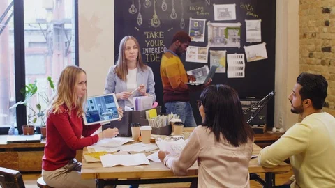 Female Designers Using Tablet and Showing Interior Project to Clients Stock Footage 115451173