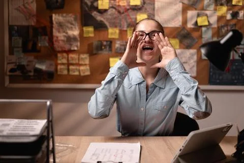 Female detective announcing something to the camera working late night with.. Stock Photos