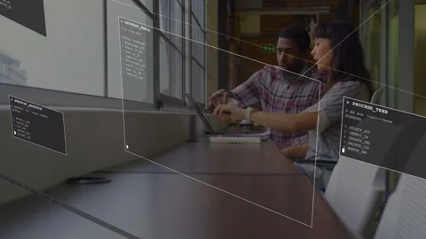 Female dev pointing laptop initiating AR code panels overlaying, male dev Stock Footage 333034916