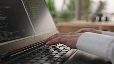 Female dev typing on laptop keyboard in tropical cafe. Software developer writes Stock Footage 248828460