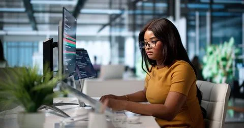 Female Developer Compares Code Changes Using A Visual Merge Tool. Photos