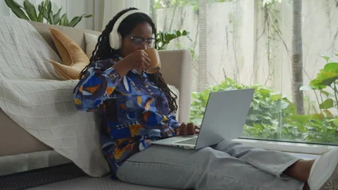 Female Developer Drinking Coffee and Working on Laptop from Home on Floor 動画素材 293730629