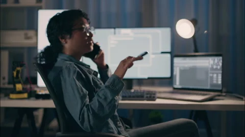 Female Developer on Late Night Call Solving Tech Issues. Stock Footage 307586674