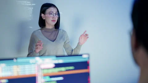 Female Developer Leading a Night Coding Workshop with HTML Code Projection. Stock Footage 300247006