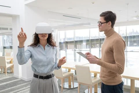 Female developer of metaverse making presentation of new project to colleague Stock Photos