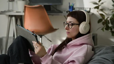 Female Developer Reviewing Vibe Coding Agent Script on Tablet and Enjoying Music Stock Footage 335941367