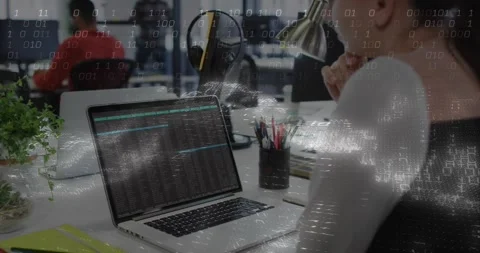 Female developer studying code starting binary overlay drifting across desk Stock Footage 317206852