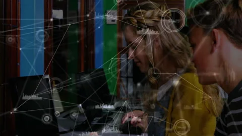 Female developer typing initiating data overlays then male colleague pointing Stock Footage 312915974