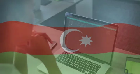 Female developer typing on office desk, with terminal graphics and Azerbaijani Stock Footage 309036245