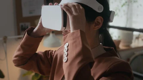 Female Developer Using Headset while Testing VR Application in Office Video stock 306215062