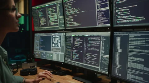 Female Developer Using Multiple Displays And Coding In Office Stock Footage 223195071