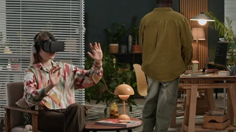 Female Developer Working in AR Headset Coworking with Man Coding on Gadgets Stock Footage 302894202