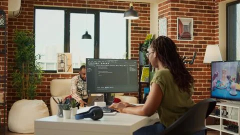 Female developer working on IT software program to create web database Stock Photos