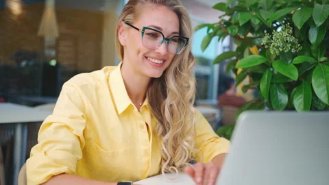 Female developer working on laptop sitting terrace cafe. Stock Footage 243094653