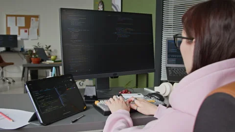 Female Developer Writing Algorithm Using Vibe Coding Assistant in Office Stock Footage 335939150