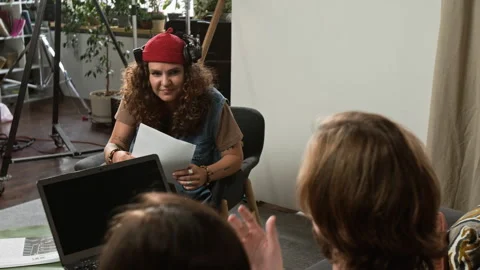 Female Director Discussing Script with Creative Team 動画素材 348271405